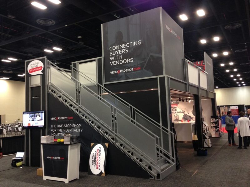 Good graphic messeaging on two story trade show exhibit rental